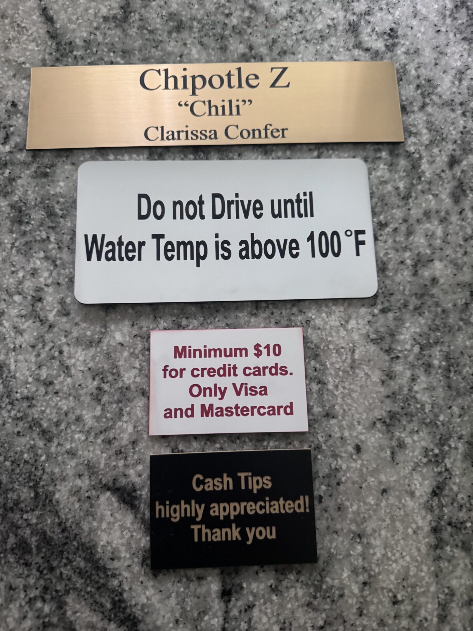 Stacked warning and informational signs on wall